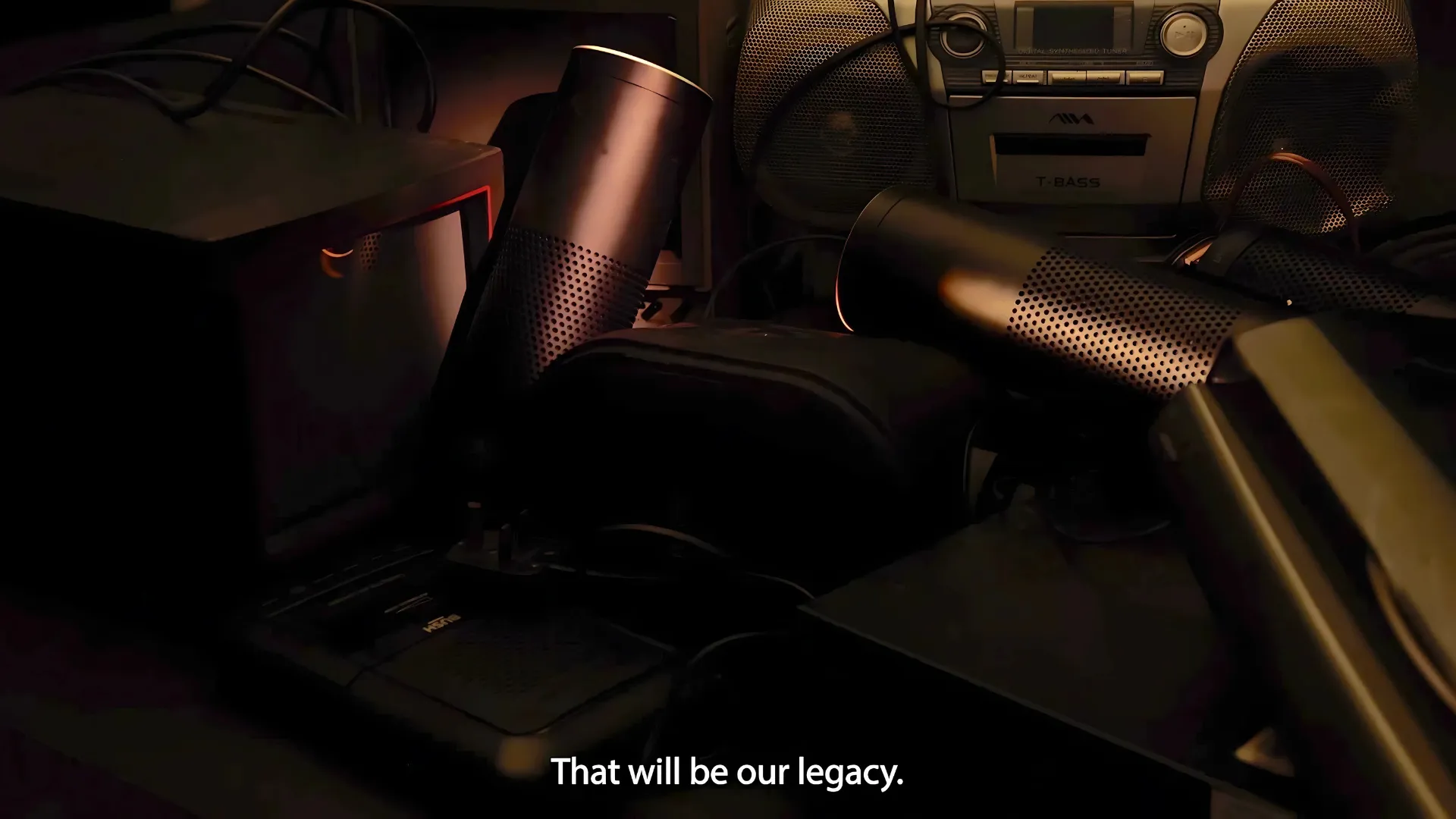 A pile of discarded Amazon Echoes with the phrase 'that will be our legacy' on subtitles.