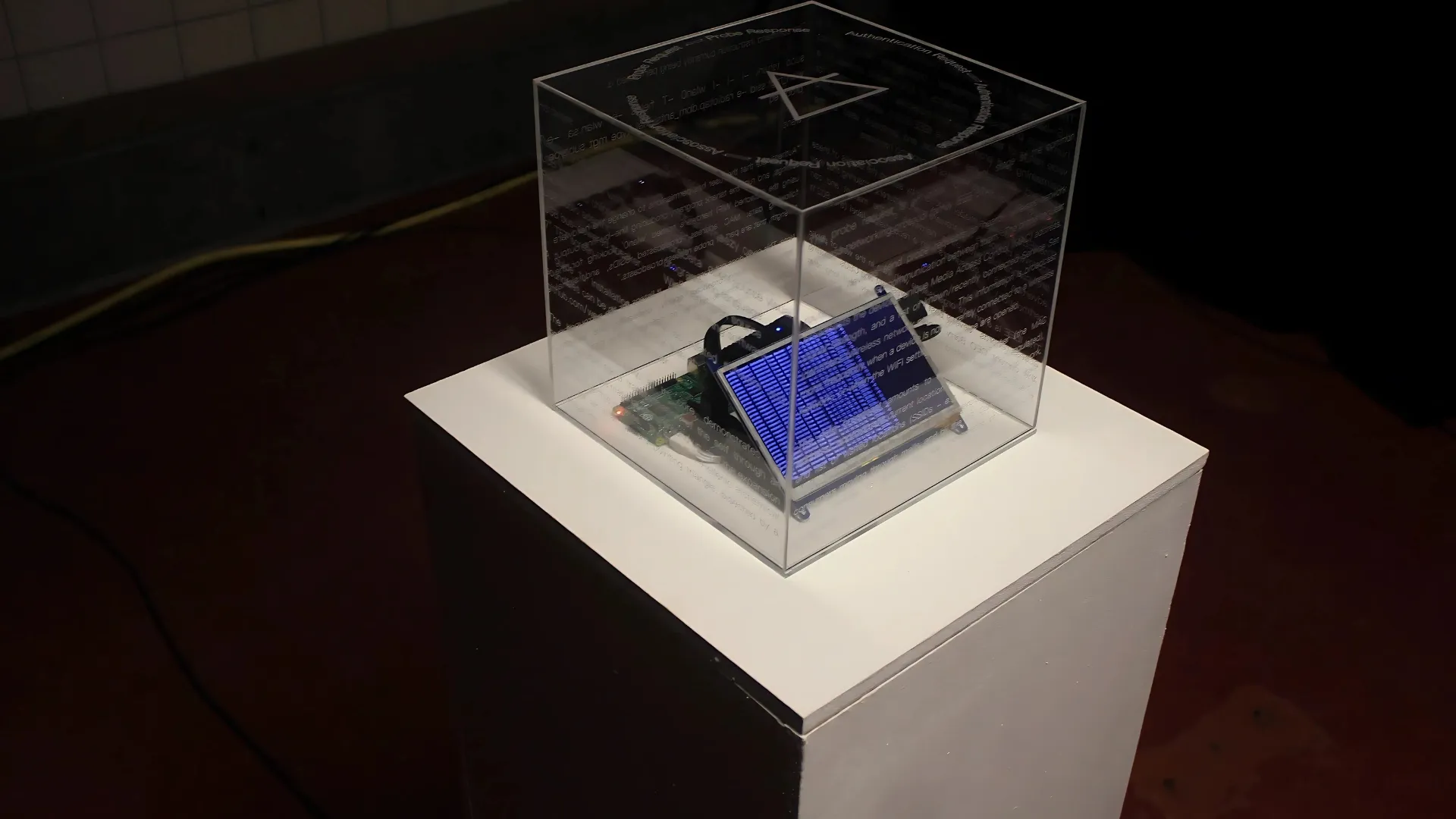 Detail view of the installation, a perspex box with Raspberry Pi and screen inside.