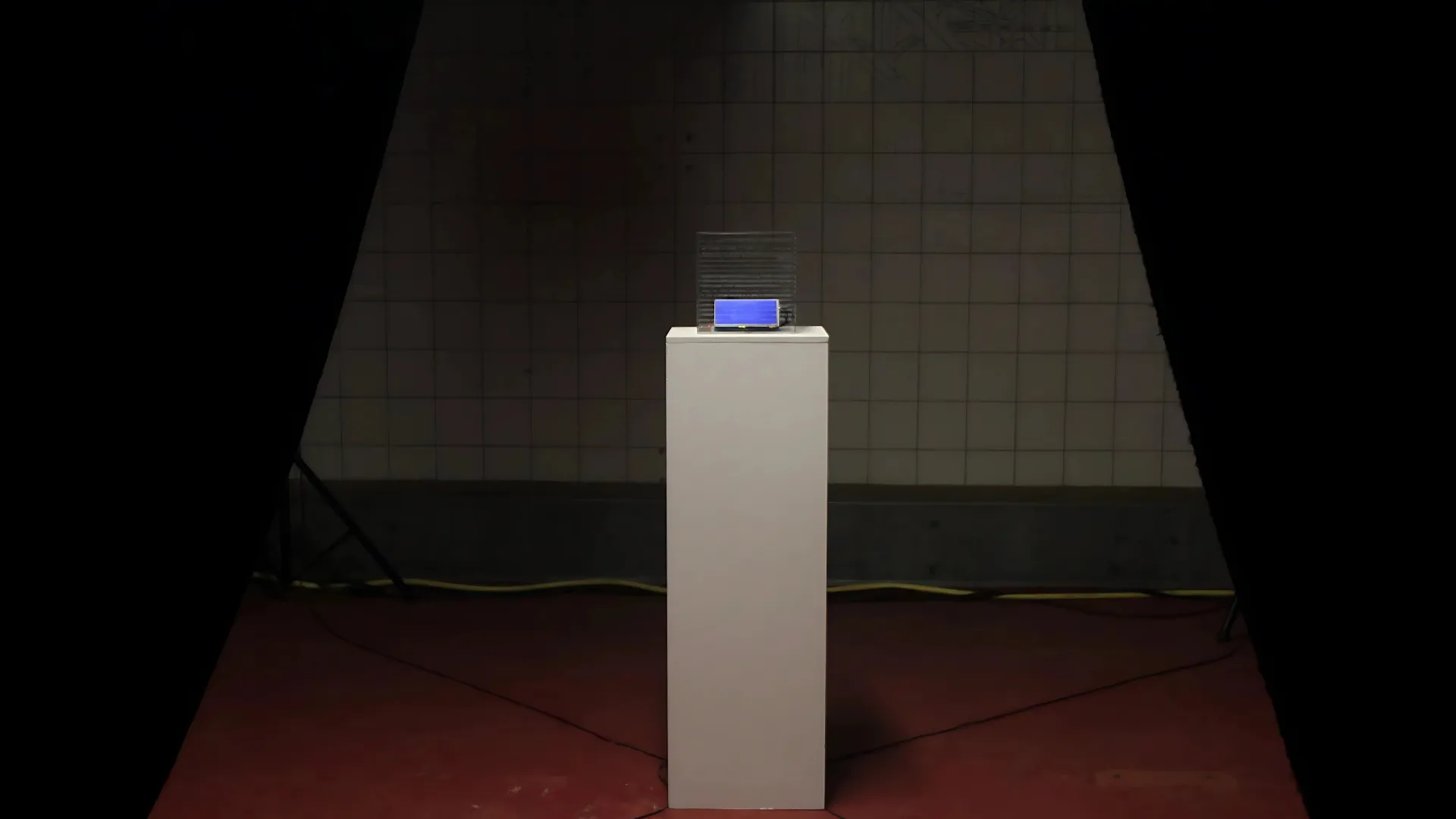 A transparent acrylic cube with electronic components inside, glowing.