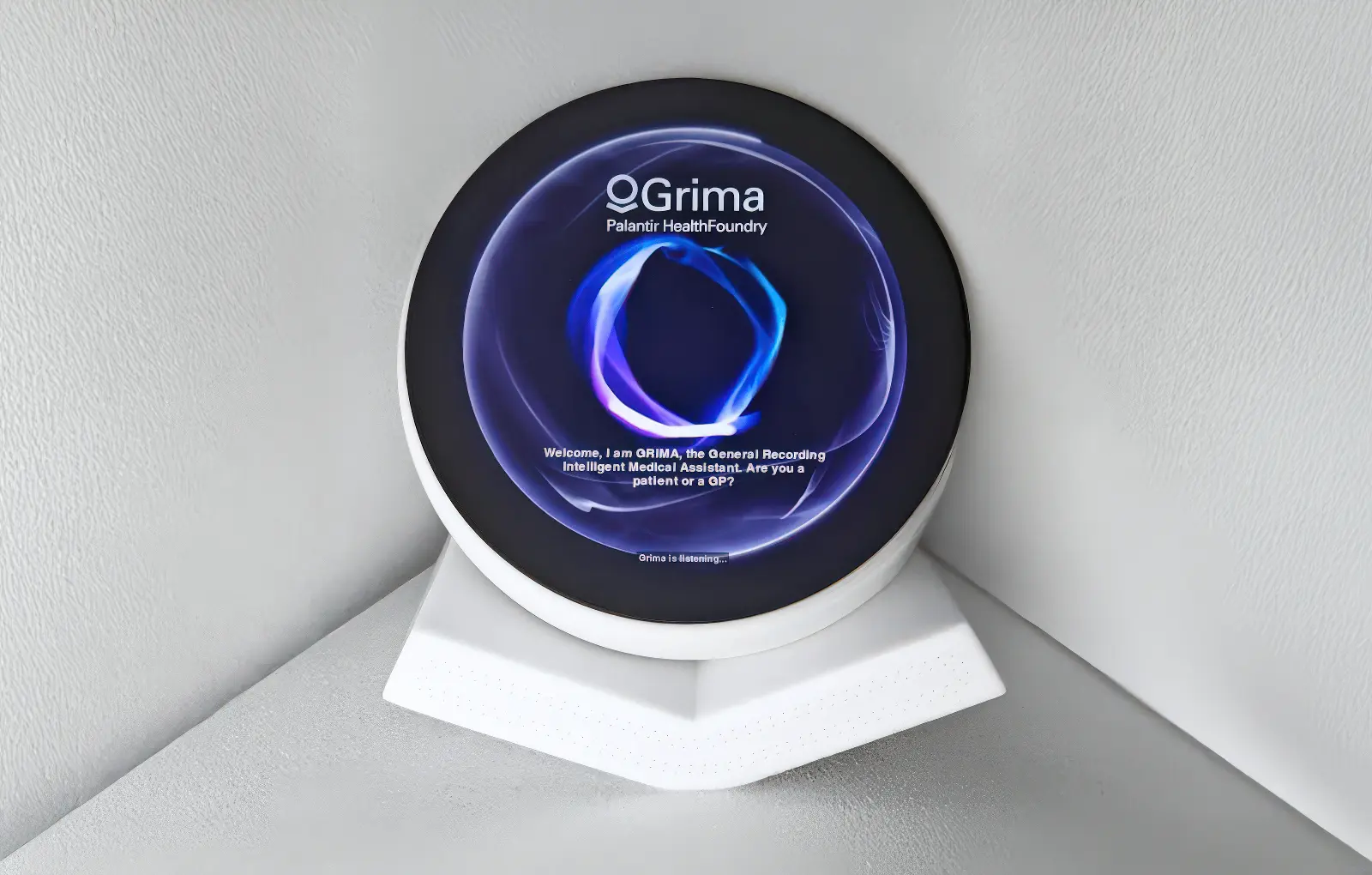 An image showing the device on a white plinth.  The device resembles the Palantir logo and has a circular screen embedded in it.
